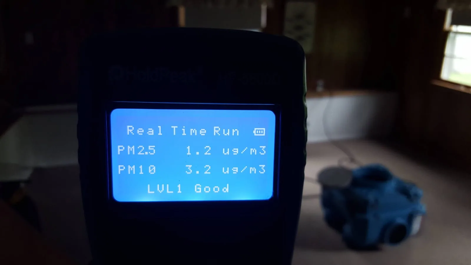 HoldPeak air quality meter showing PM2.5 and PM10 levels at LVL1 Good after remediation